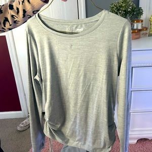 This is a grey loose fitting sport shirt that you can adjust the length on.